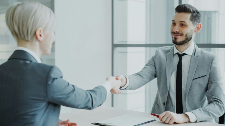 A recruiter shaking hands with a new hire